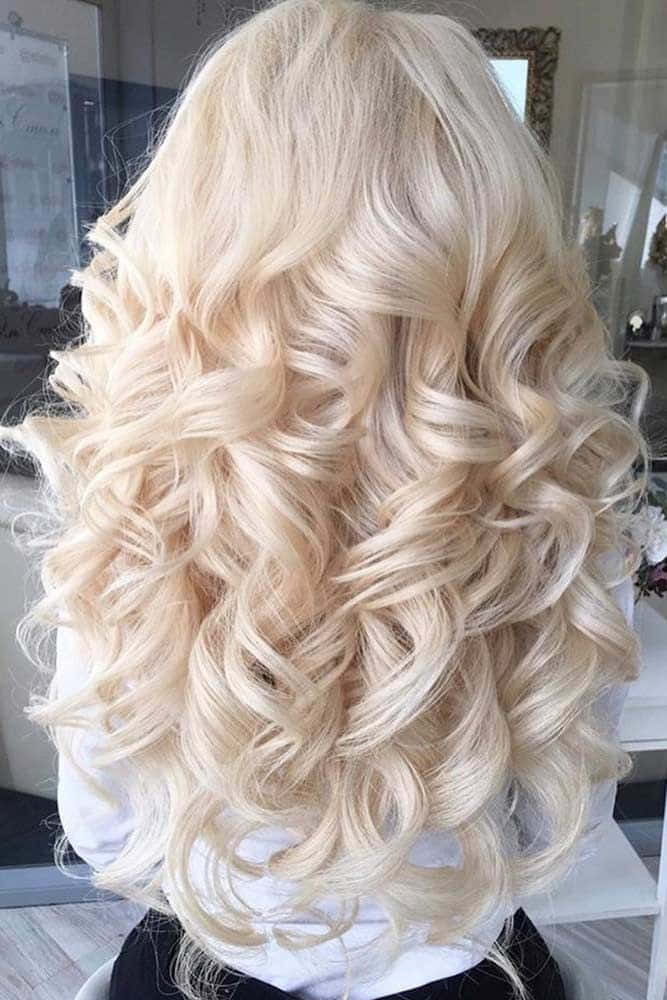 A Woman With Long Blonde Hair In A Salon