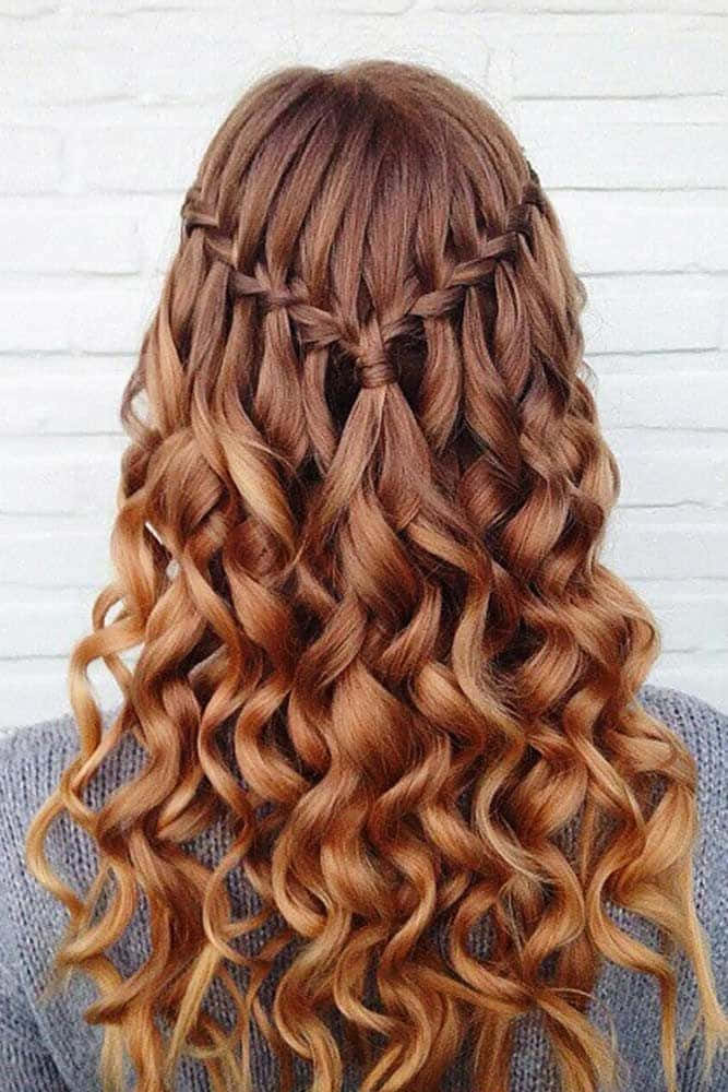 A Woman With Long Curly Hair In A Braid