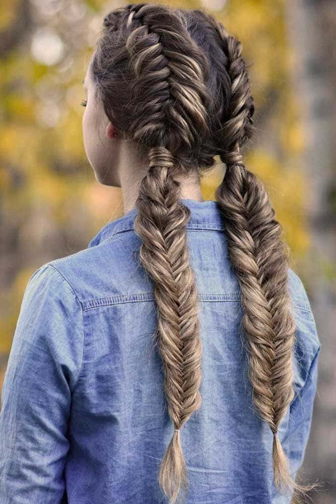 A Girl With Long Hair And Fishtail Braids