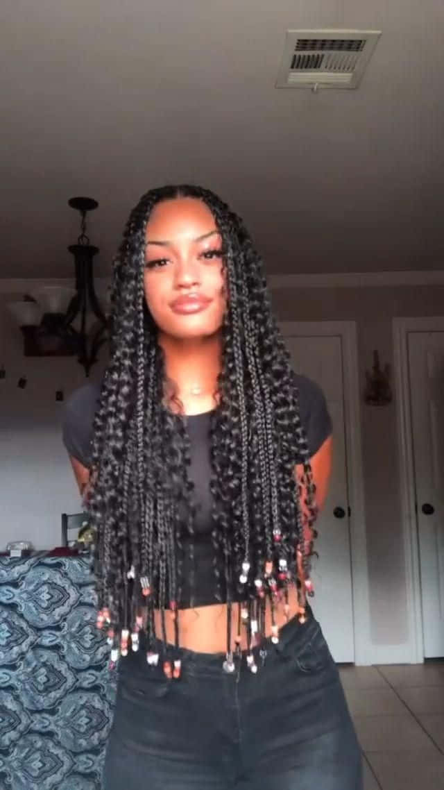 A Woman With Long Braids In Her Hair