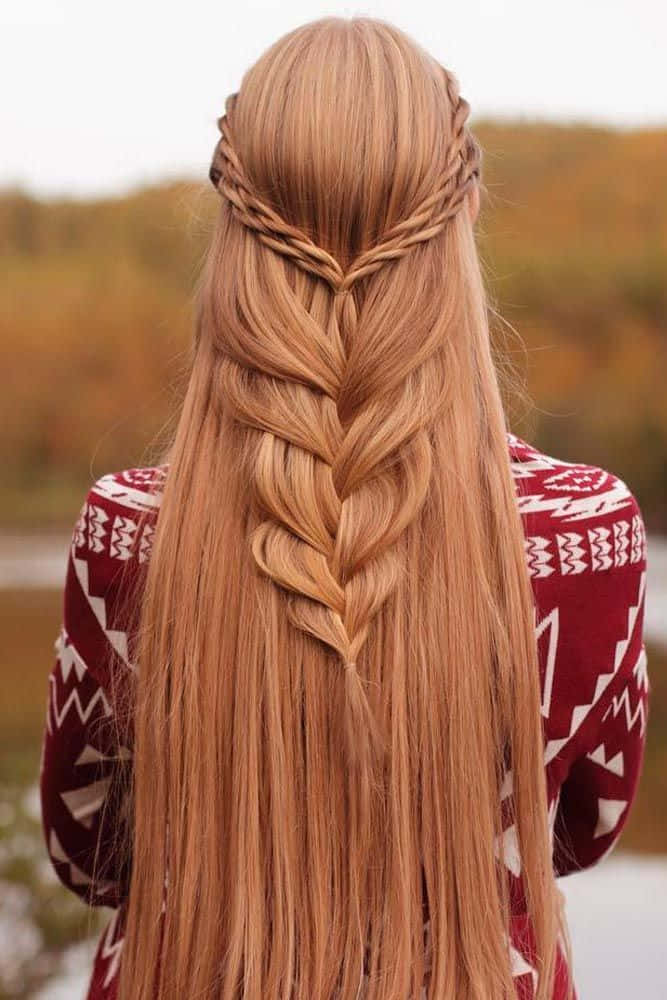 A Woman With Long Blonde Hair In A Braid