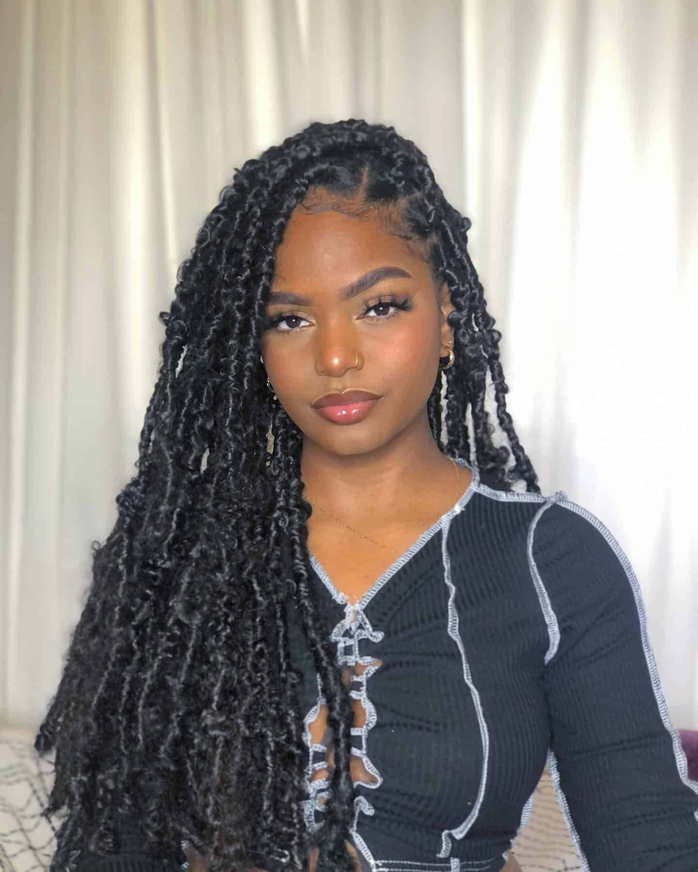 A Woman With Long Braids And A Black Top