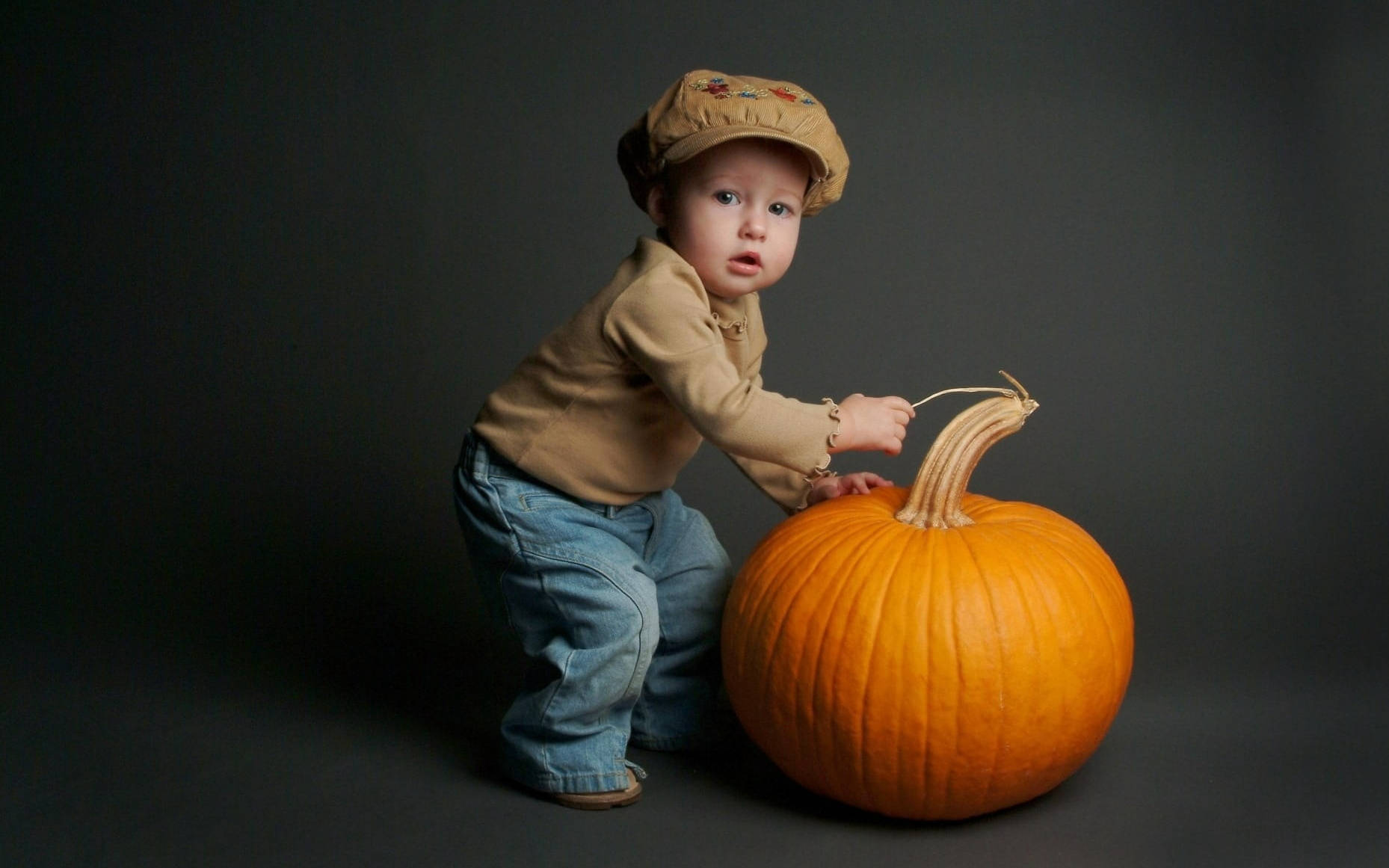Cute Halloween Toddler Over Pumpkin Wallpaper