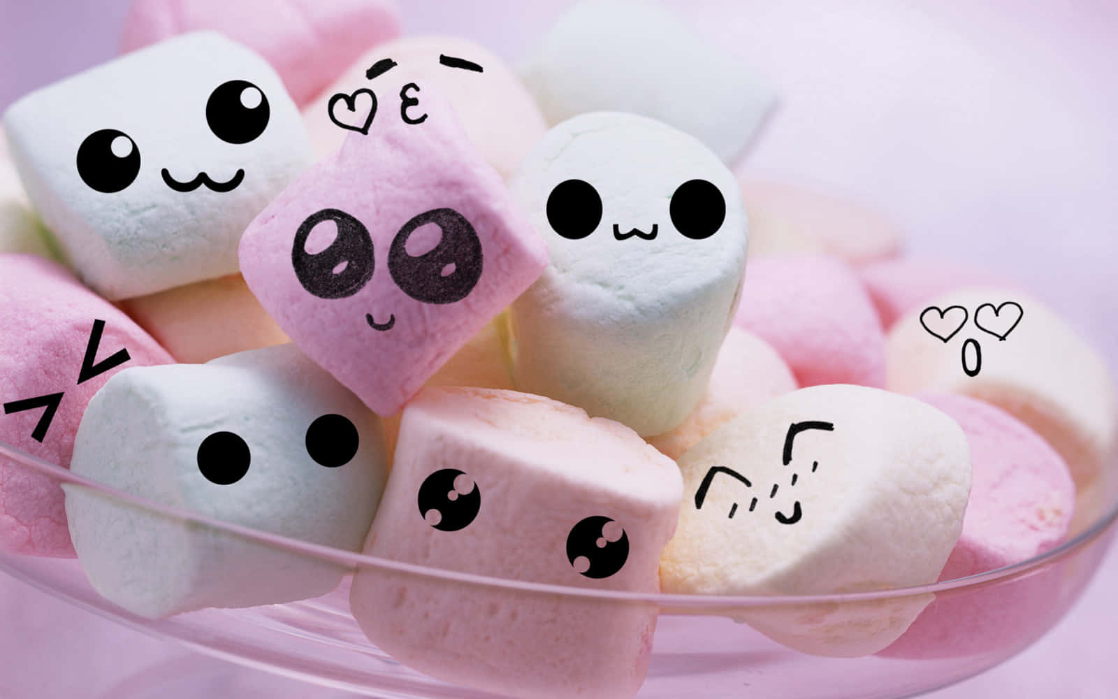 A Bowl Of Marshmallows With Cute Faces On Them