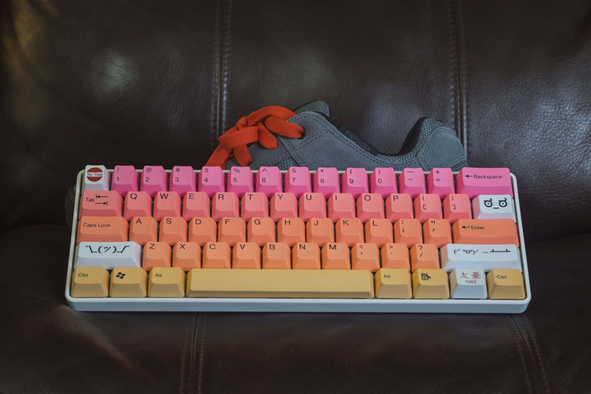 A Pink And Orange Keyboard With A Pair Of Sneakers