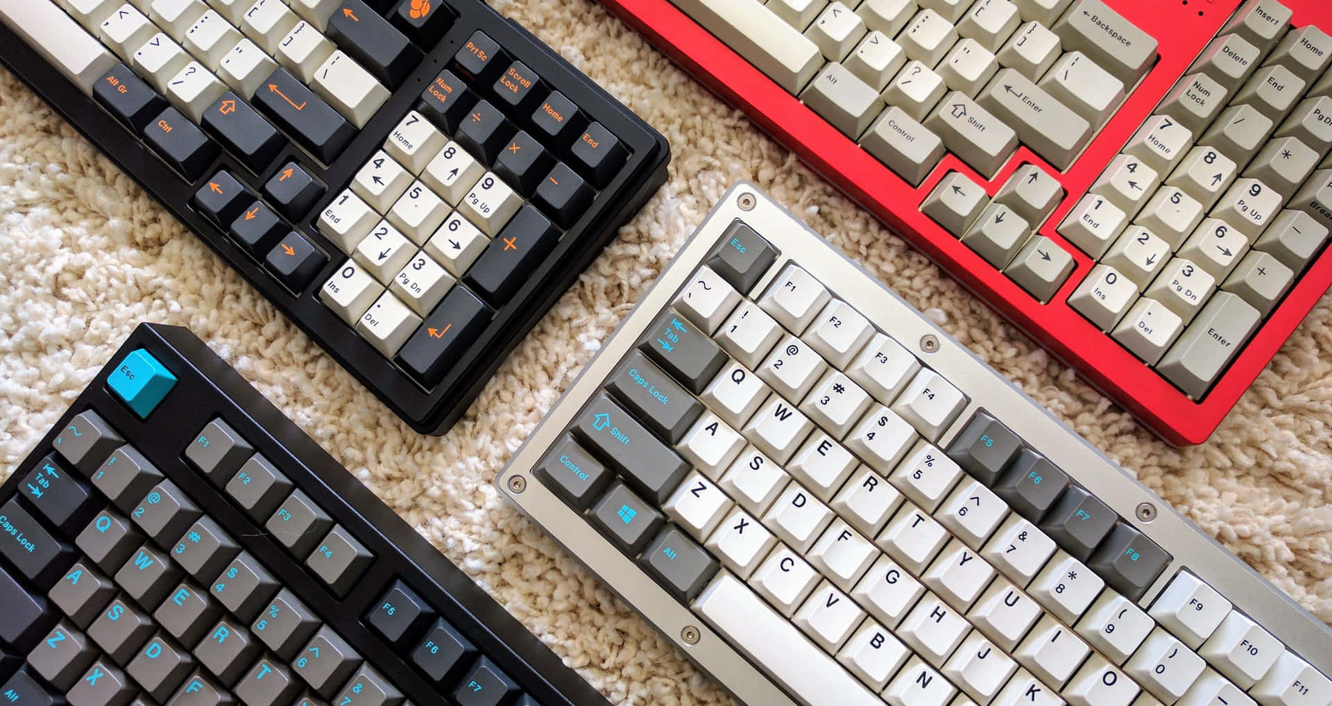 A Group Of Keyboards On A Carpet