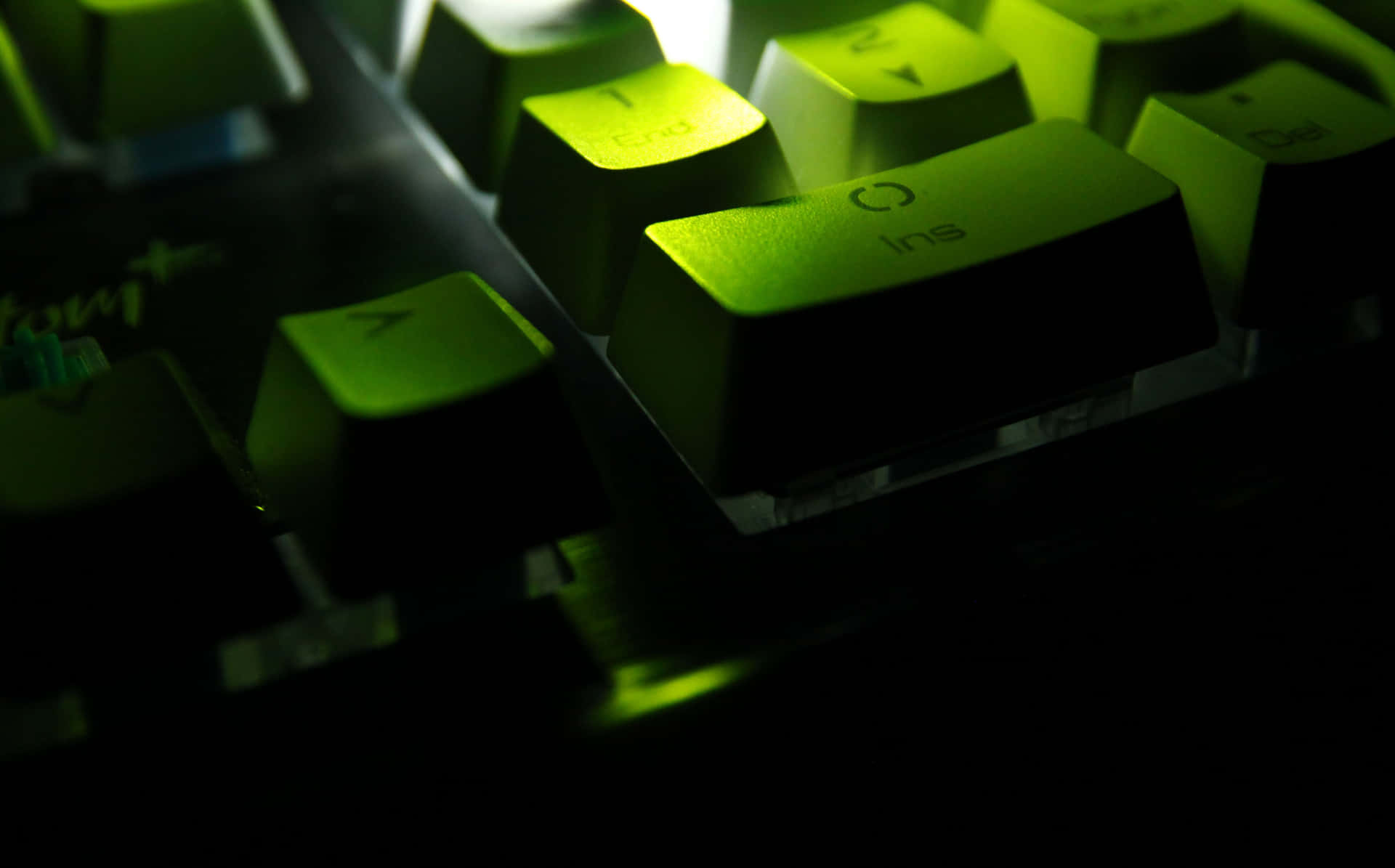 A Green Keyboard With A Light Shining On It