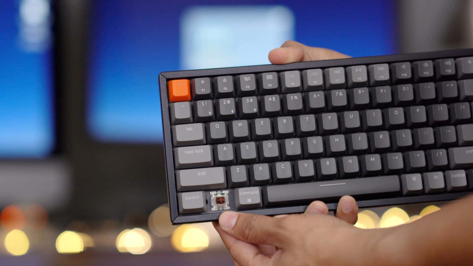 A Person Holding A Keyboard With A Black Keypad