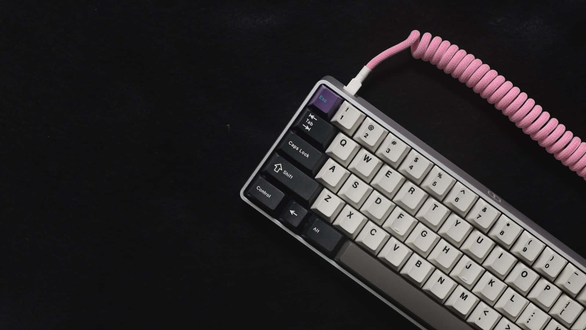 A Pink Keyboard With A Pink Cord