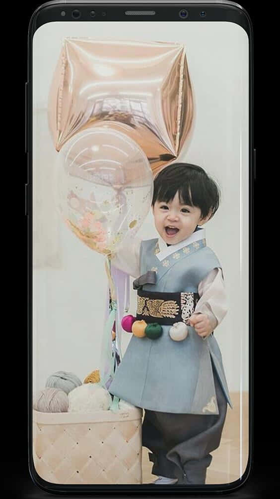Cute Korean Toddler Wearing Traditional Korean Attire Wallpaper
