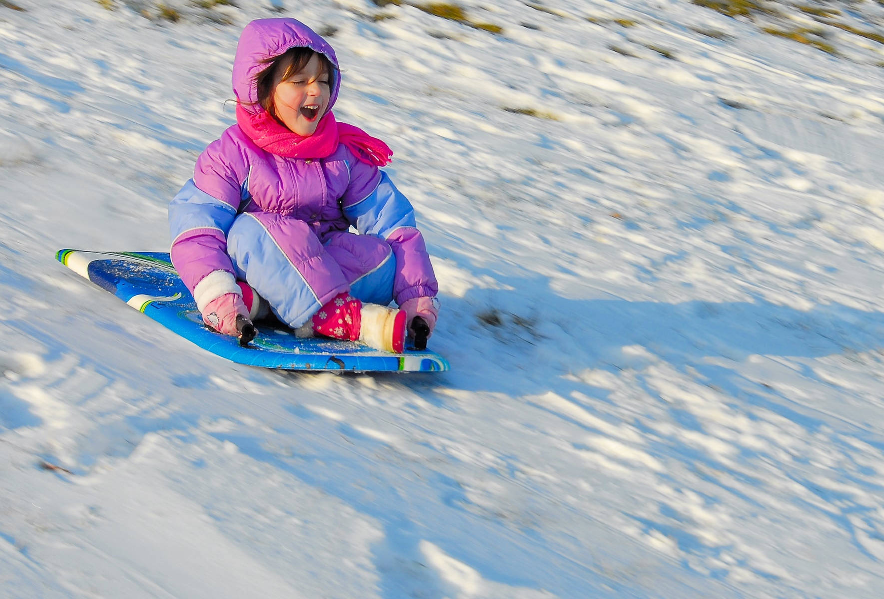 Cute Little Girl Sledding At Snow Wallpaper