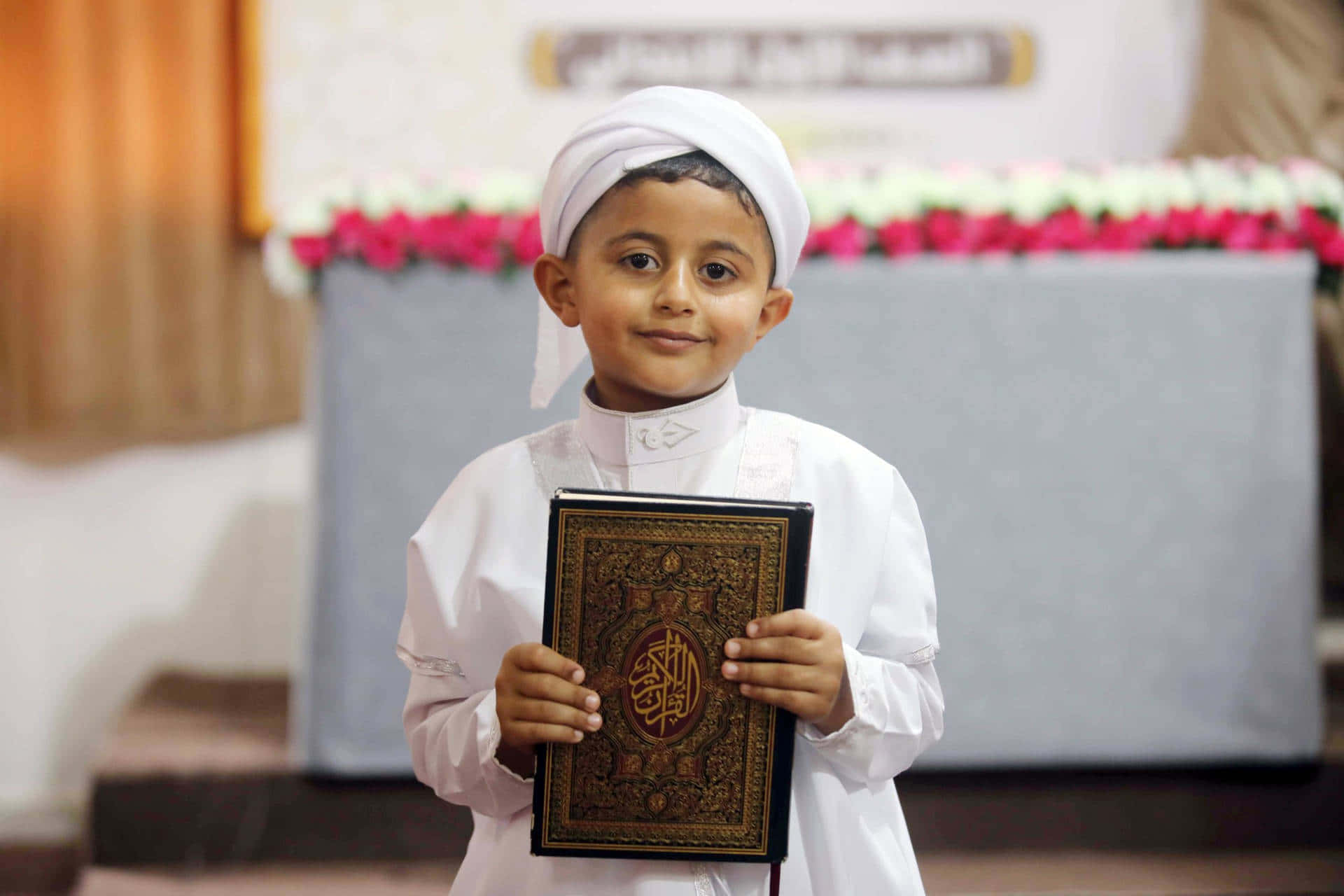 Cute Muslim Boy Holding Quran Wallpaper