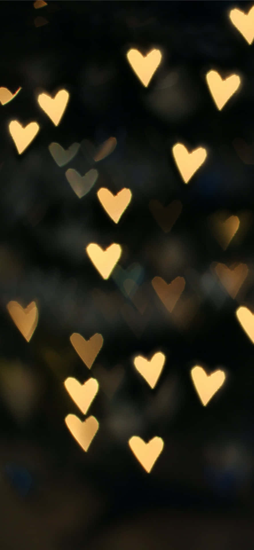 A Blurry Image Of Many Hearts In The Dark Wallpaper