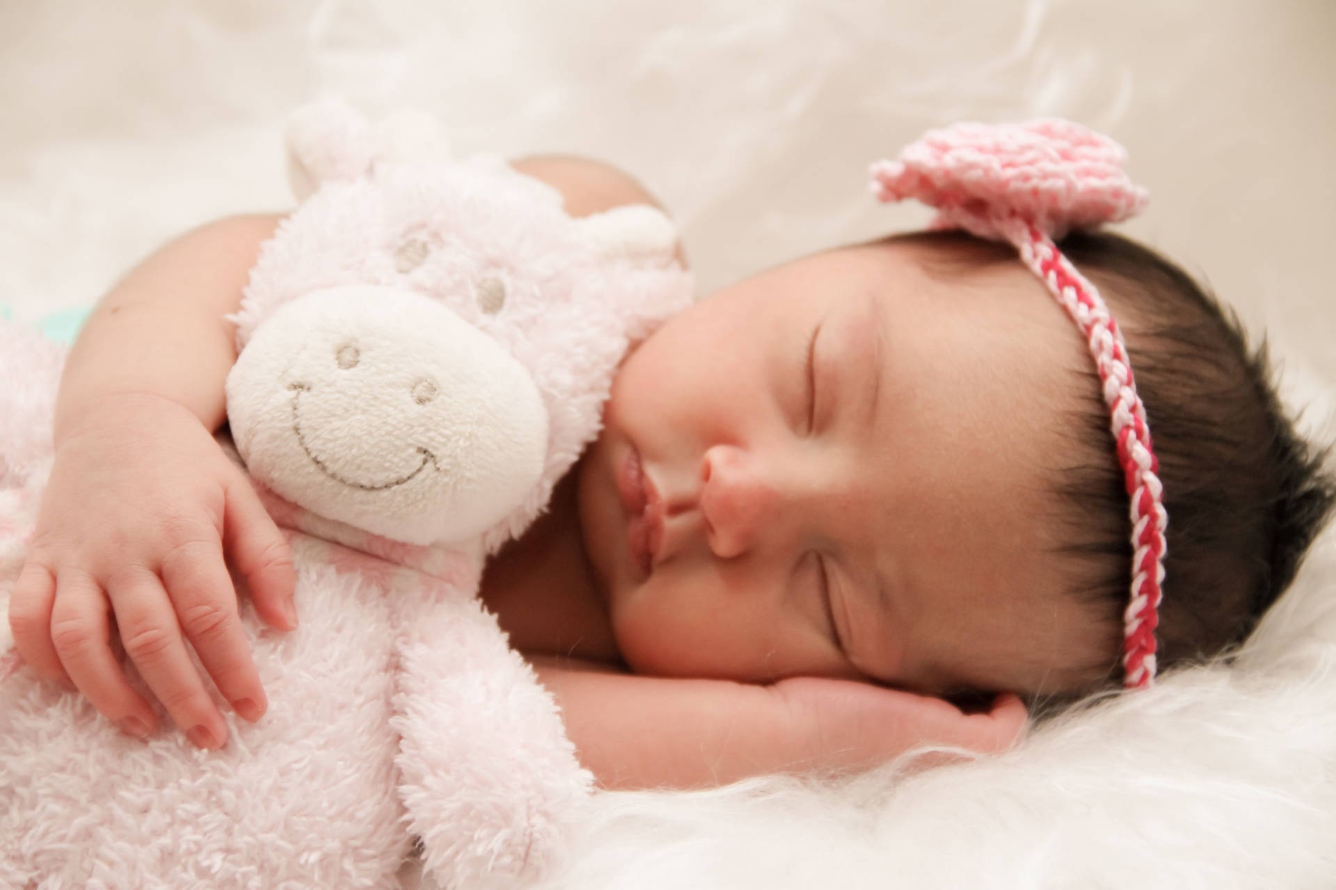 Cute Sleeping Baby With Stuffed Cow Wallpaper