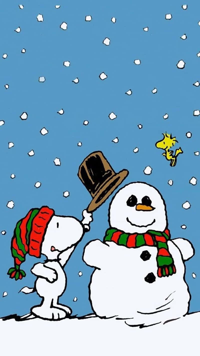 Cute Snoopy Christmas Putting Top Hat On Snowman Wallpaper
