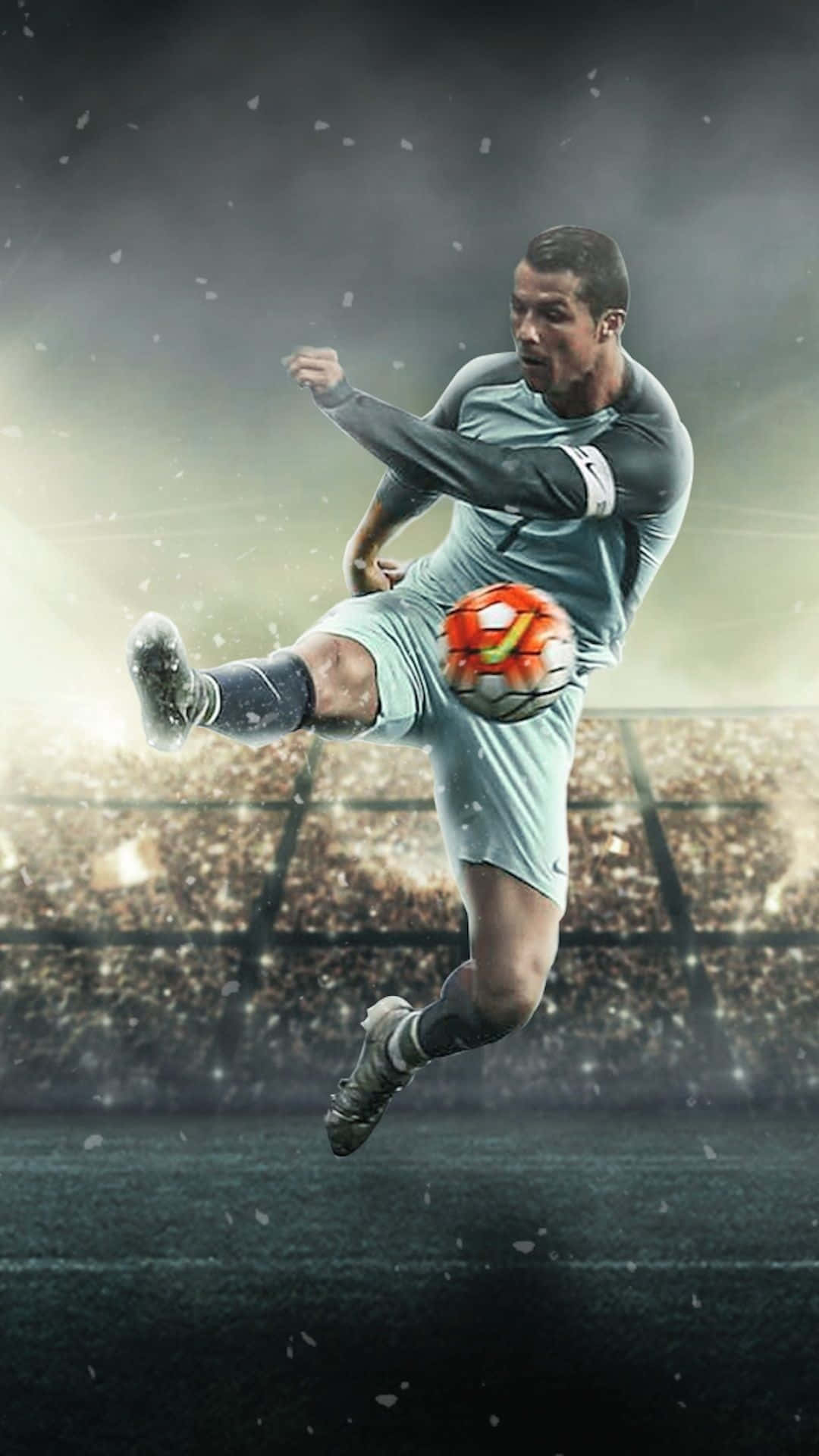 A Soccer Player Kicking A Ball In The Air Wallpaper