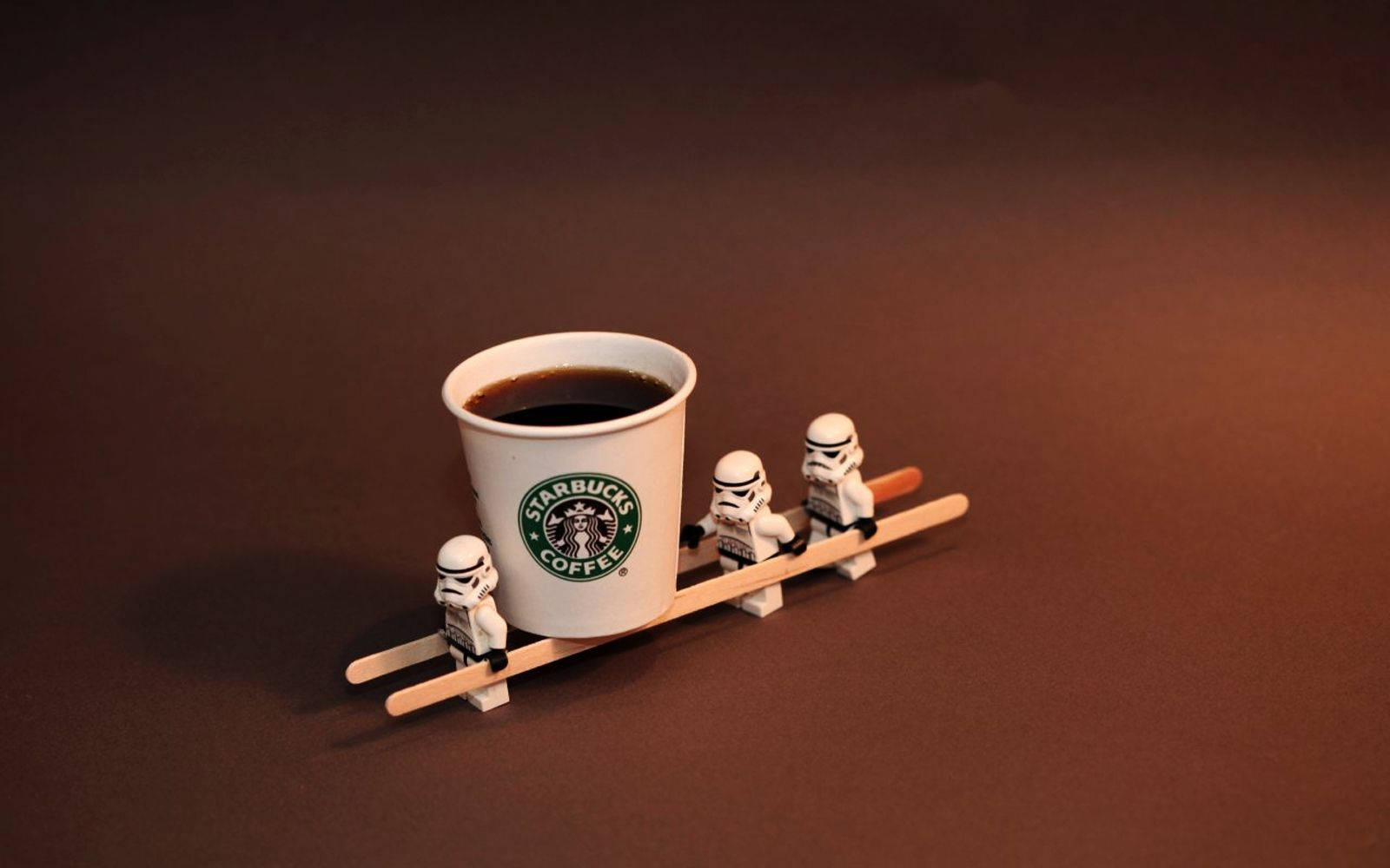 Cute Starbucks And Stormtrooper Figurines Background