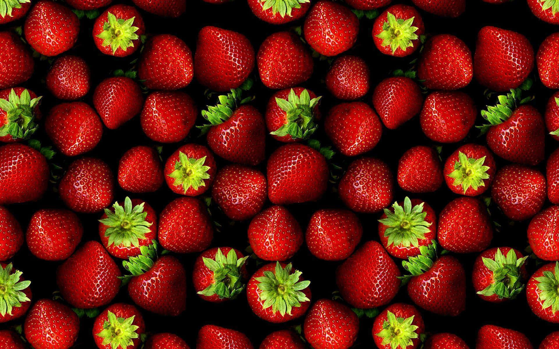 A Black Background With Many Strawberries Wallpaper