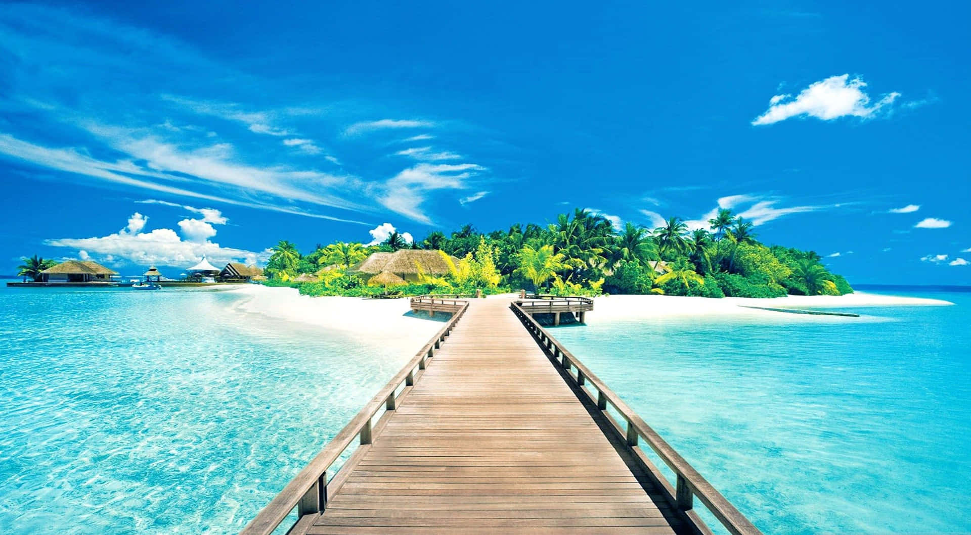 A Wooden Walkway Leading To An Island In The Ocean Wallpaper