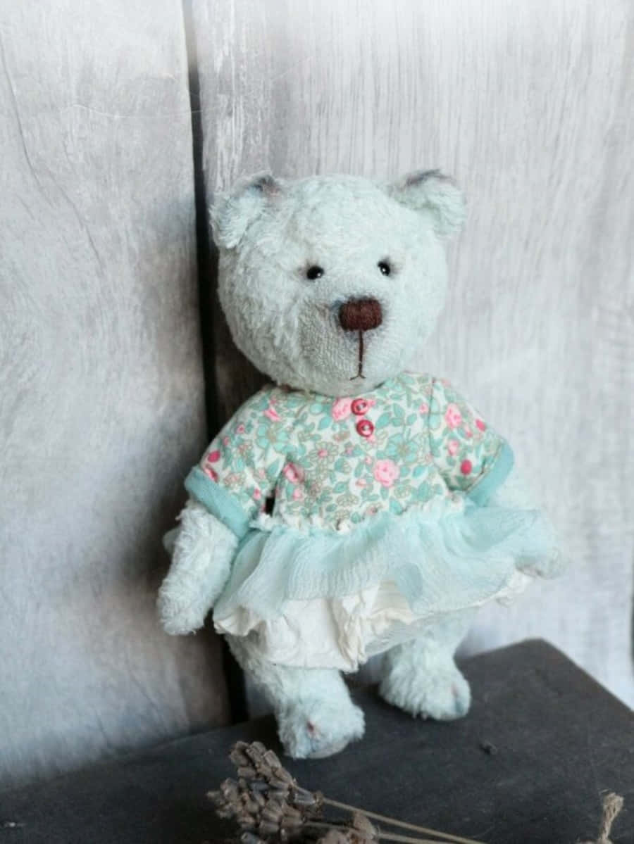 A Teddy Bear Dressed In A Blue Dress