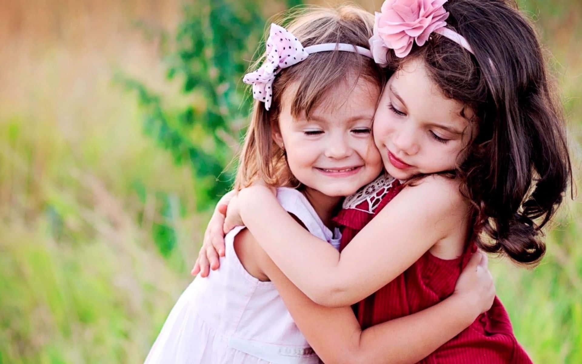 Adorable toddler siblings bonding and smiling outdoors Wallpaper