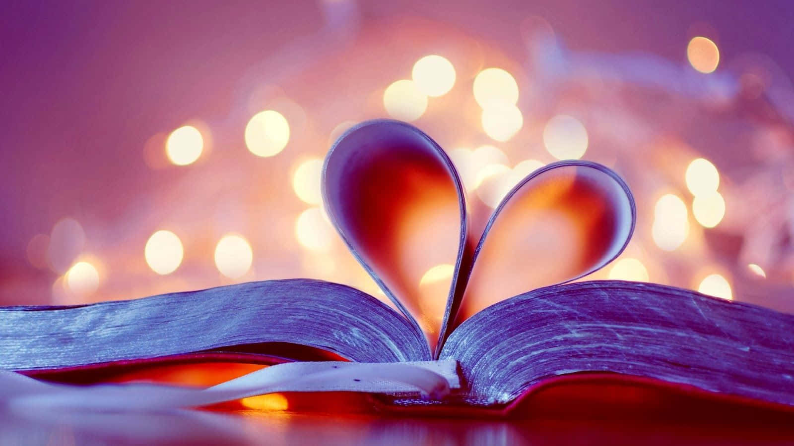A Book With Hearts On It And Lights Behind It Wallpaper