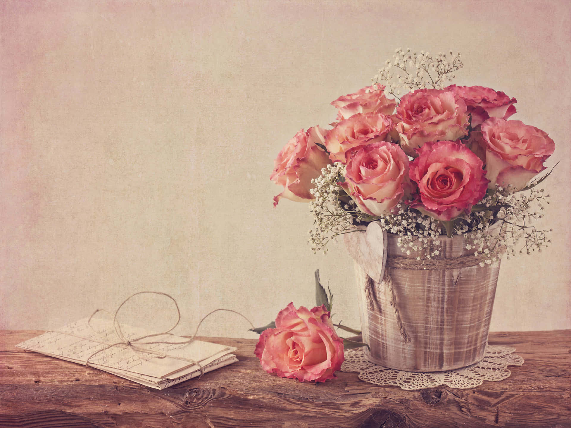Vintage Roses In A Vase On A Wooden Table Wallpaper
