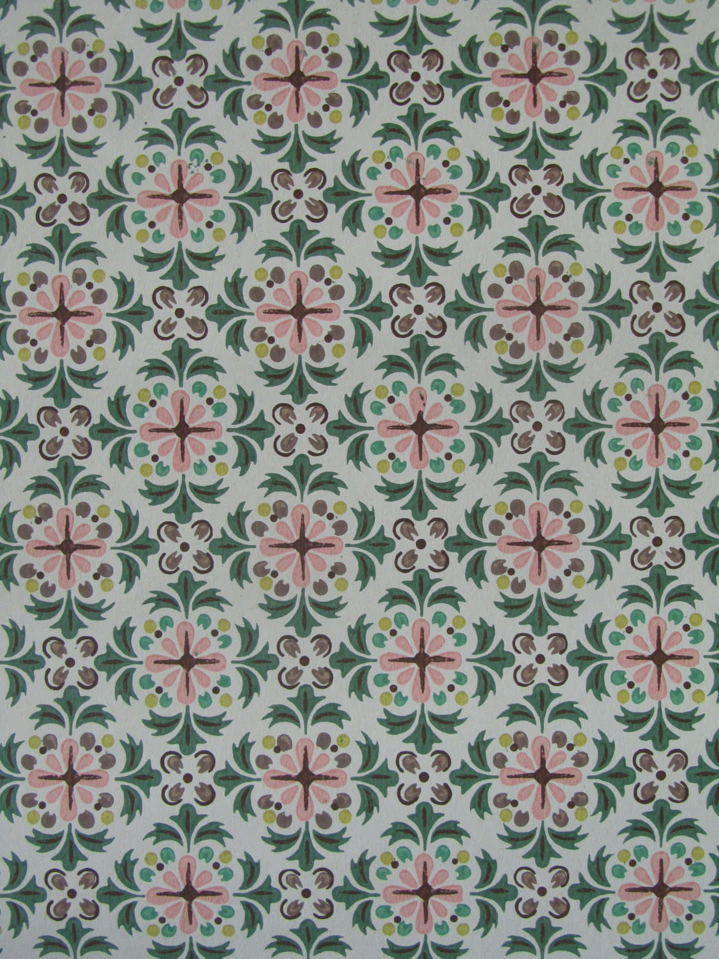 A Green And Pink Tile With Floral Designs Wallpaper