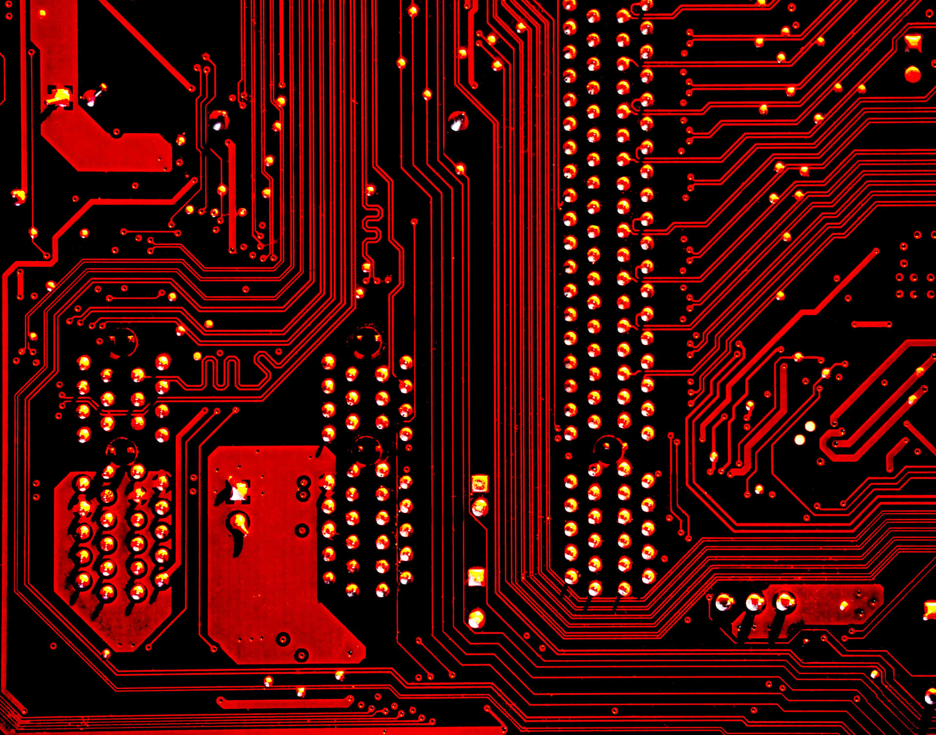 A Red Circuit Board With Red And Black Circuits