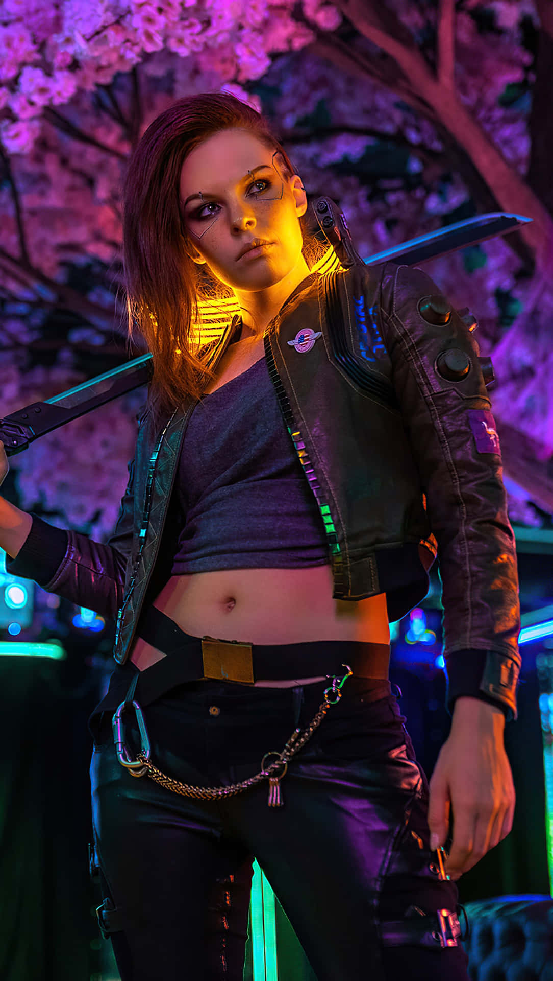 A group of captivating Cyberpunk 2077 characters posing against a futuristic city backdrop. Wallpaper