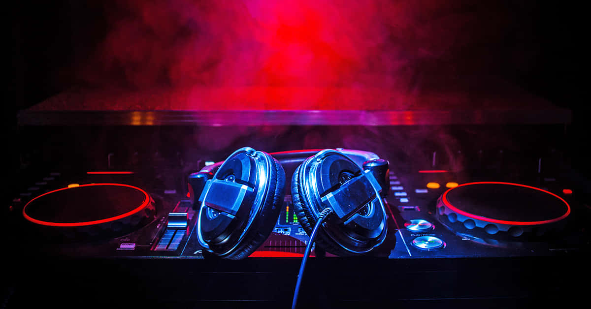 D J Headphonesand Mixer Under Red Lights Wallpaper