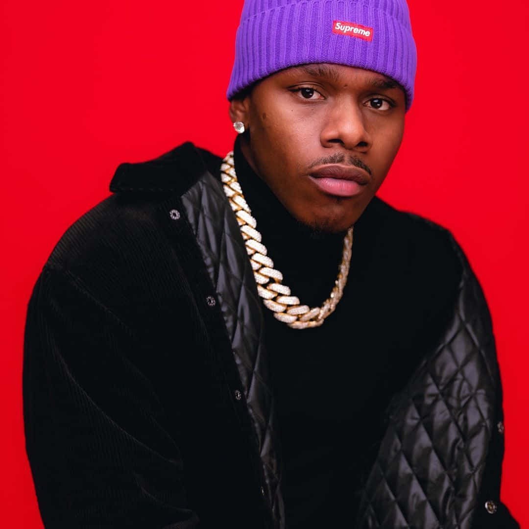 Rapper DaBaby posing in a stylish outfit