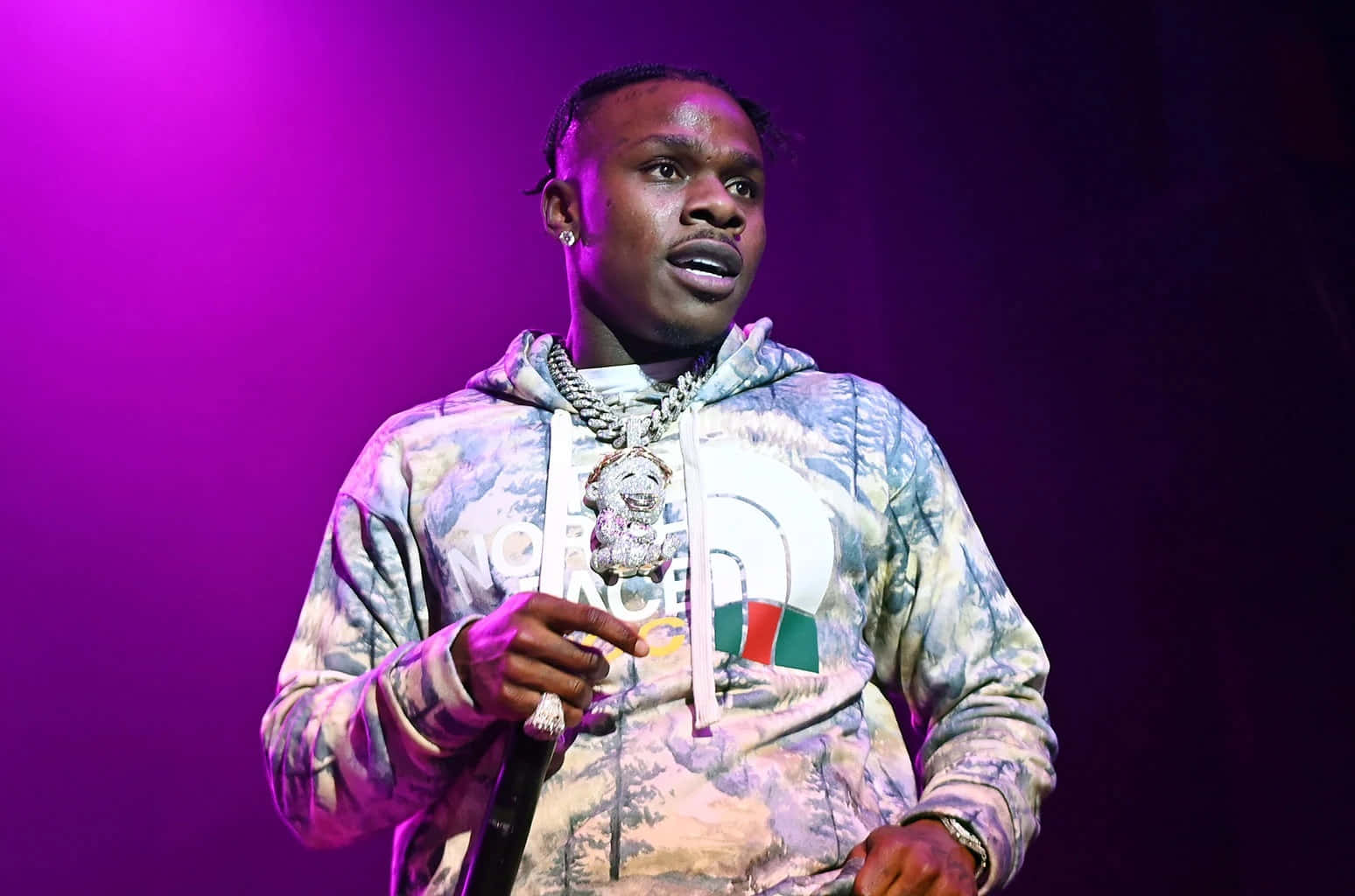 DaBaby posing in a colorful photoshoot backdrop