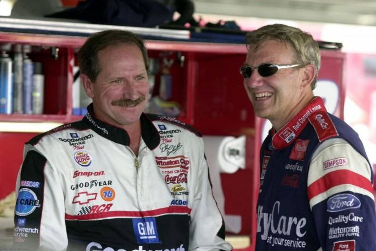 Two Men In A Nascar Uniforms Are Smiling Wallpaper