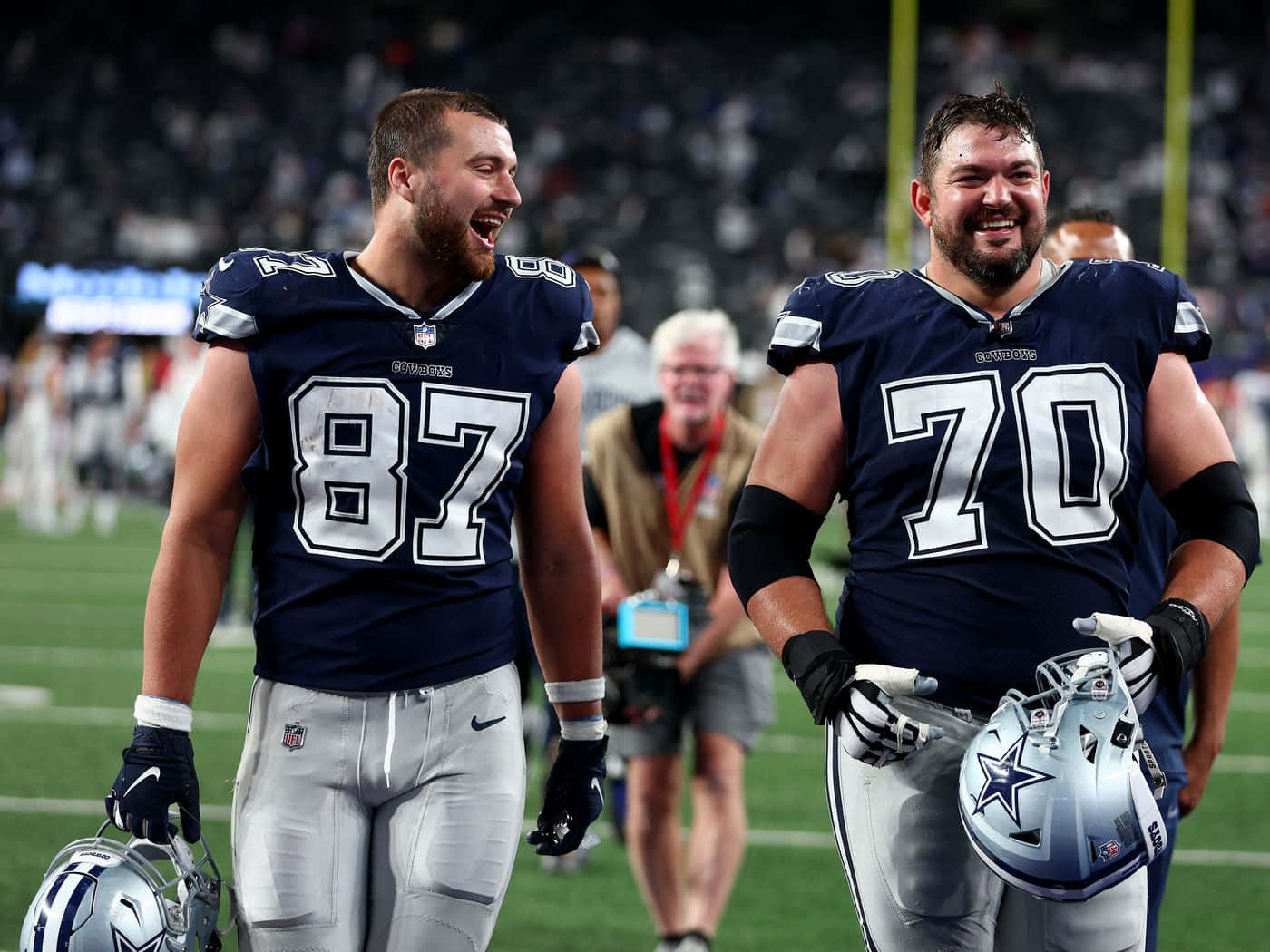 Dallas Cowboys Players Laughing On Field Wallpaper