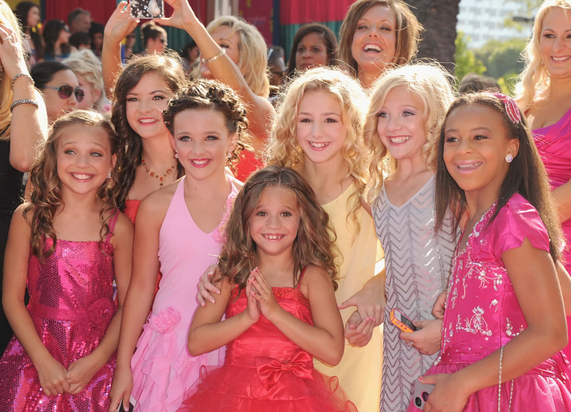 Download Dance_ Moms_ Cast_ Red_ Carpet_ Smiles Wallpaper | Wallpapers.com