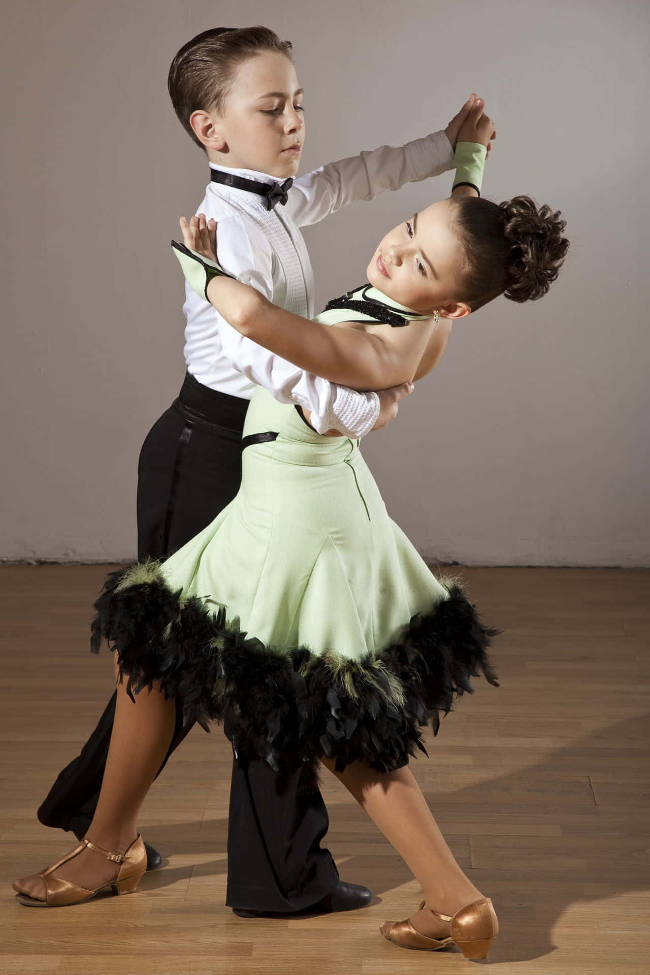 A Young Boy And Girl Dancing In A Dance Studio
