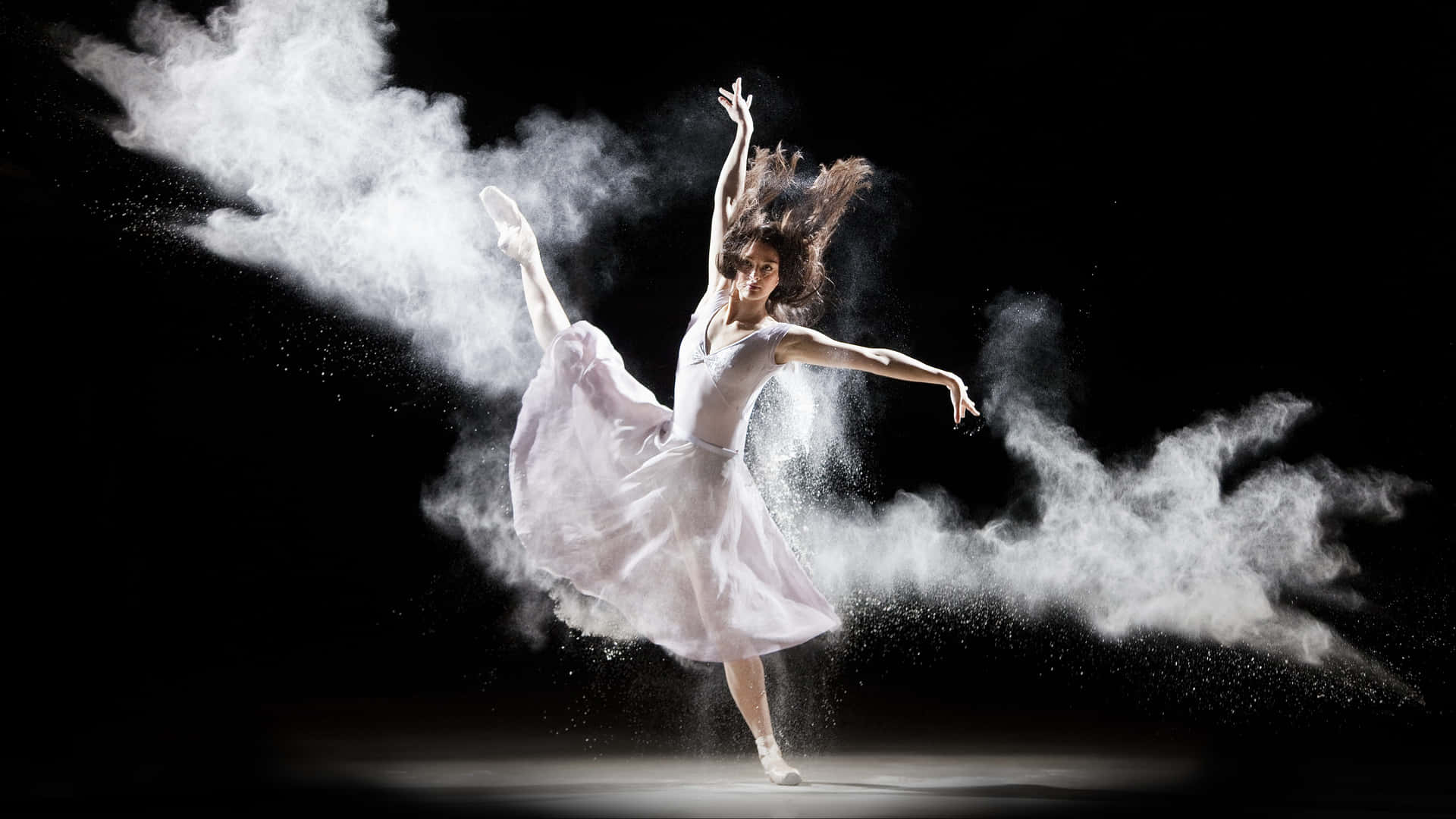 A Dancer Is Flying Through The Air With Powder