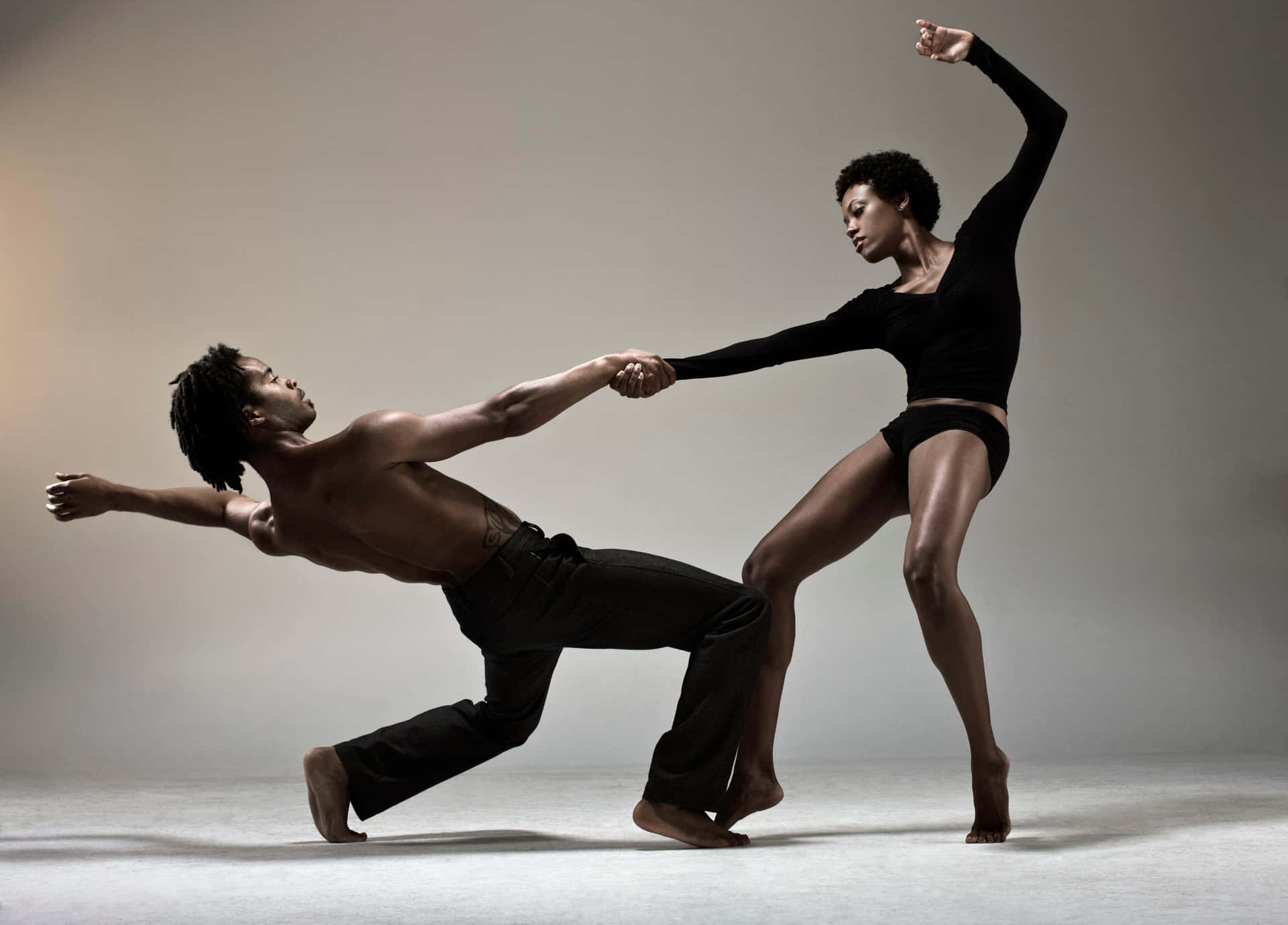 Two Dancers In A Studio Doing A Dance