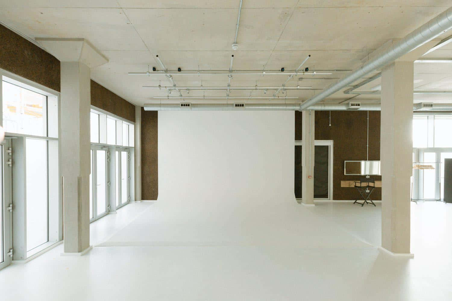 A Large Empty Room With White Walls And White Floors