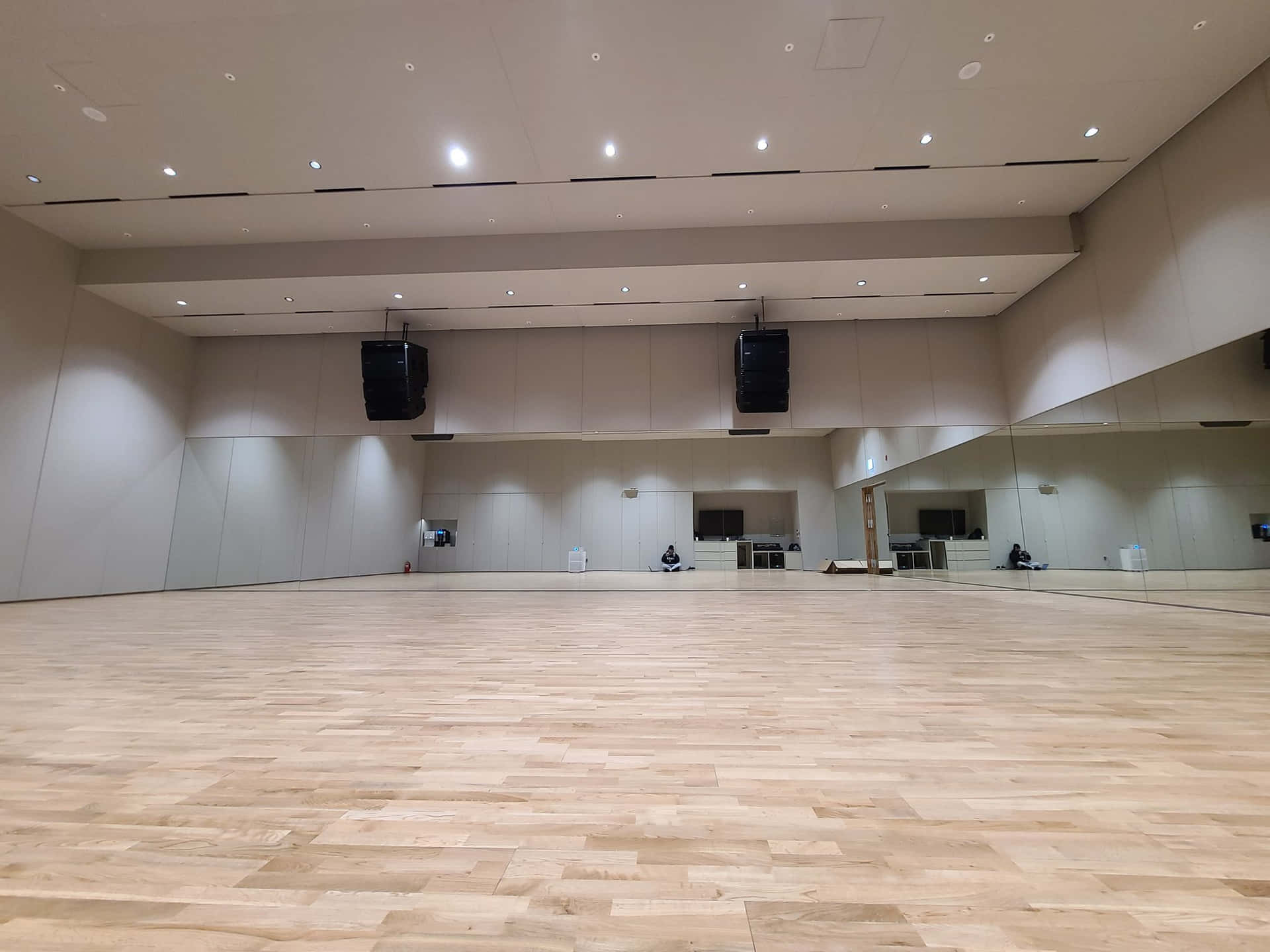 A Large Empty Dance Studio With Wooden Floors