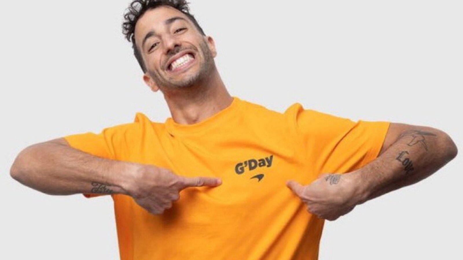 Daniel Ricciardo Posing in an Orange 'G'Day' Shirt Wallpaper