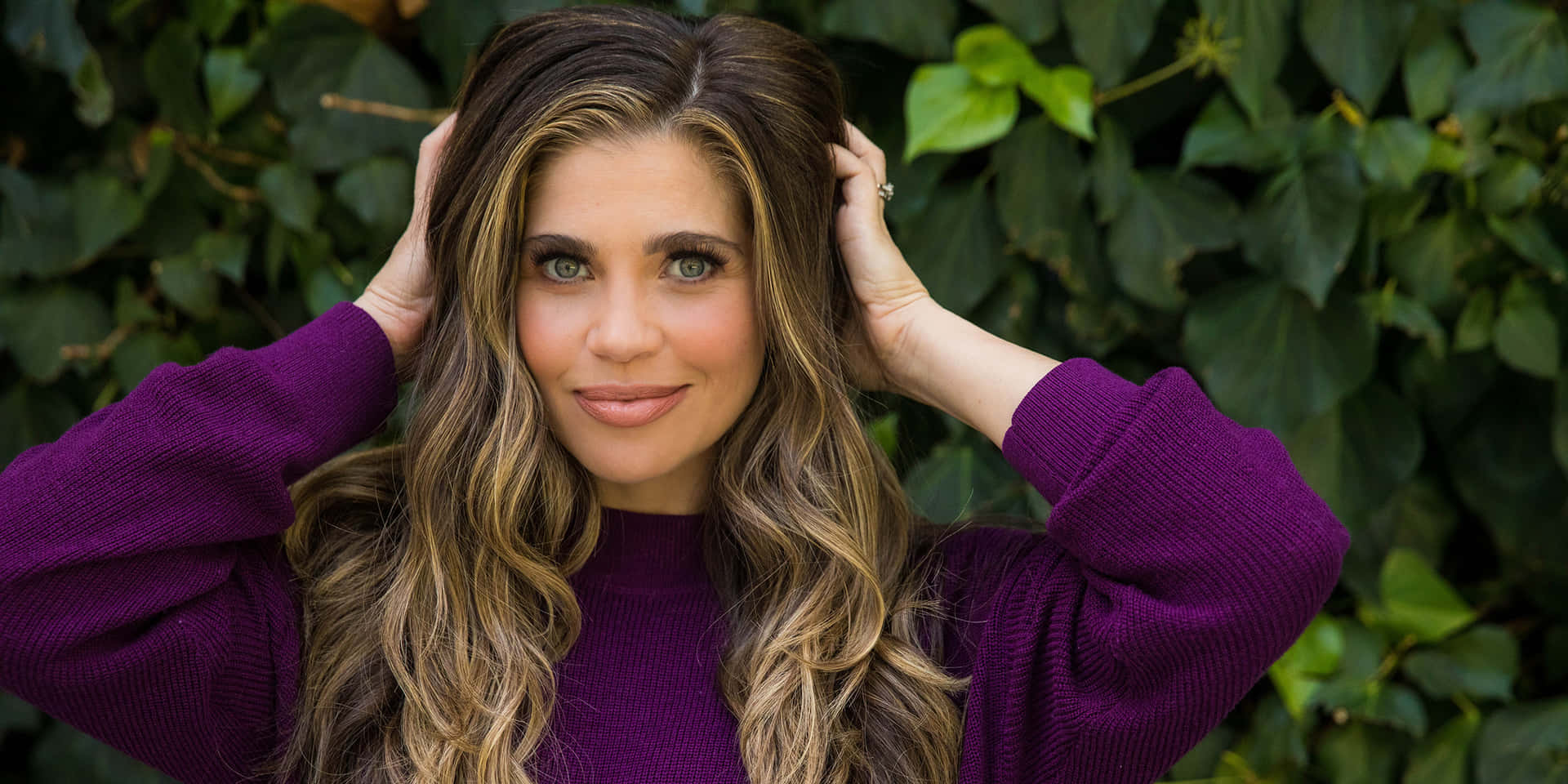 Danielle Fishel Posing with a Vibrant Background Wallpaper