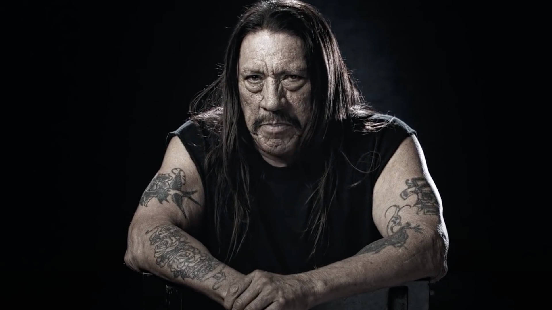 Danny Trejo With Full Sleeve Tattoos Background