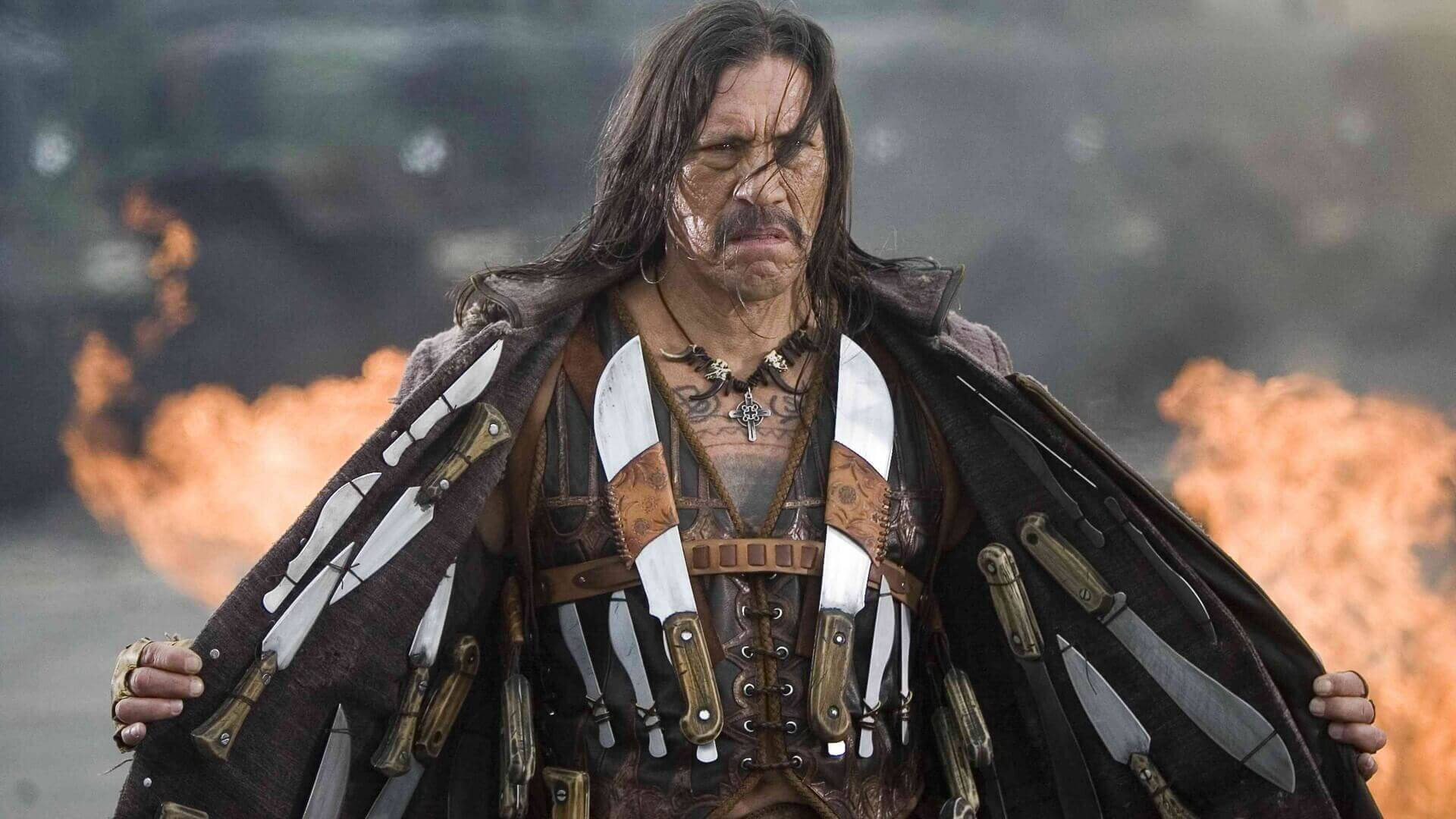 Danny Trejo With Weapons As Machete Background