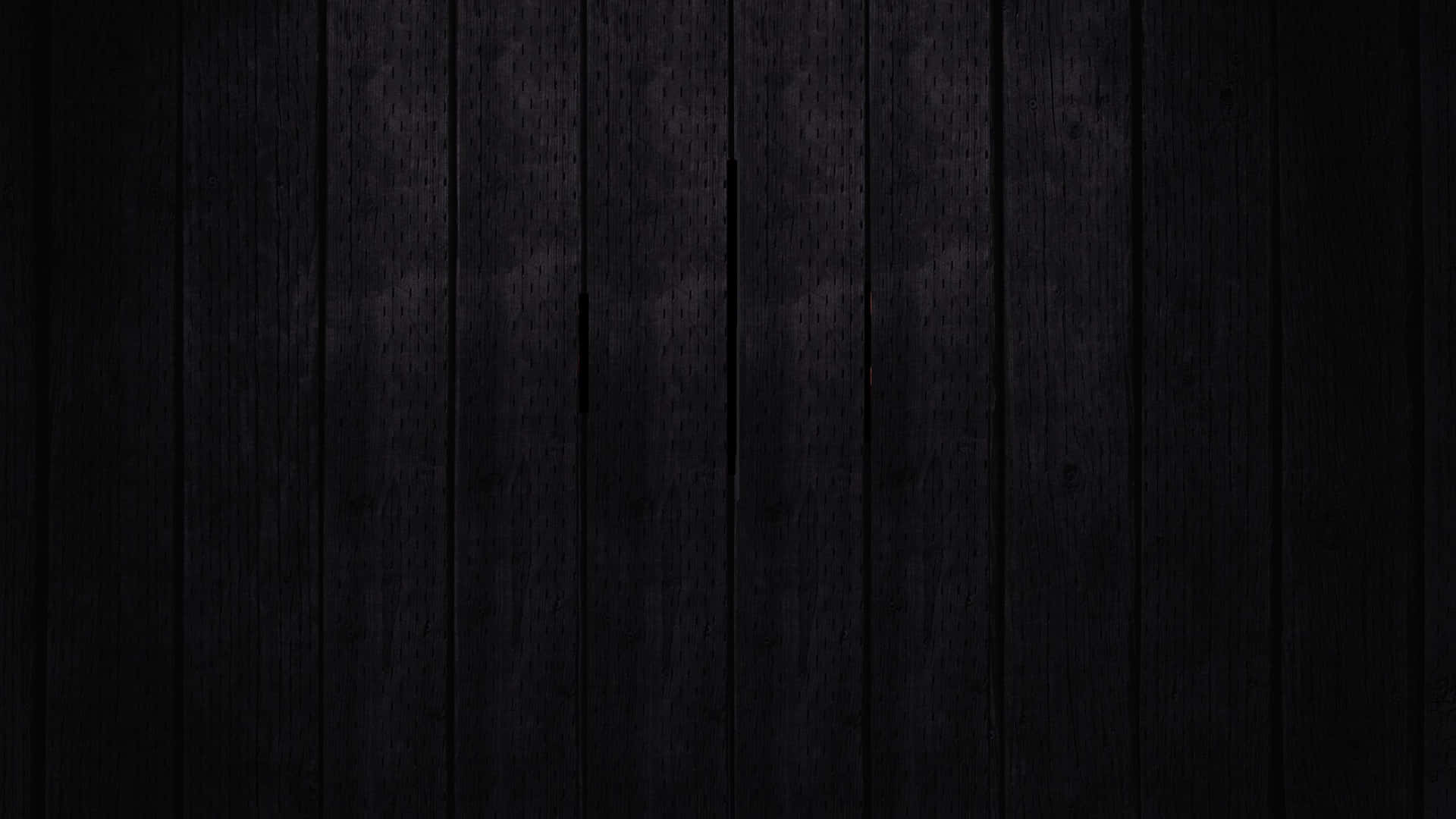 a black wooden background with a light shining on it Wallpaper