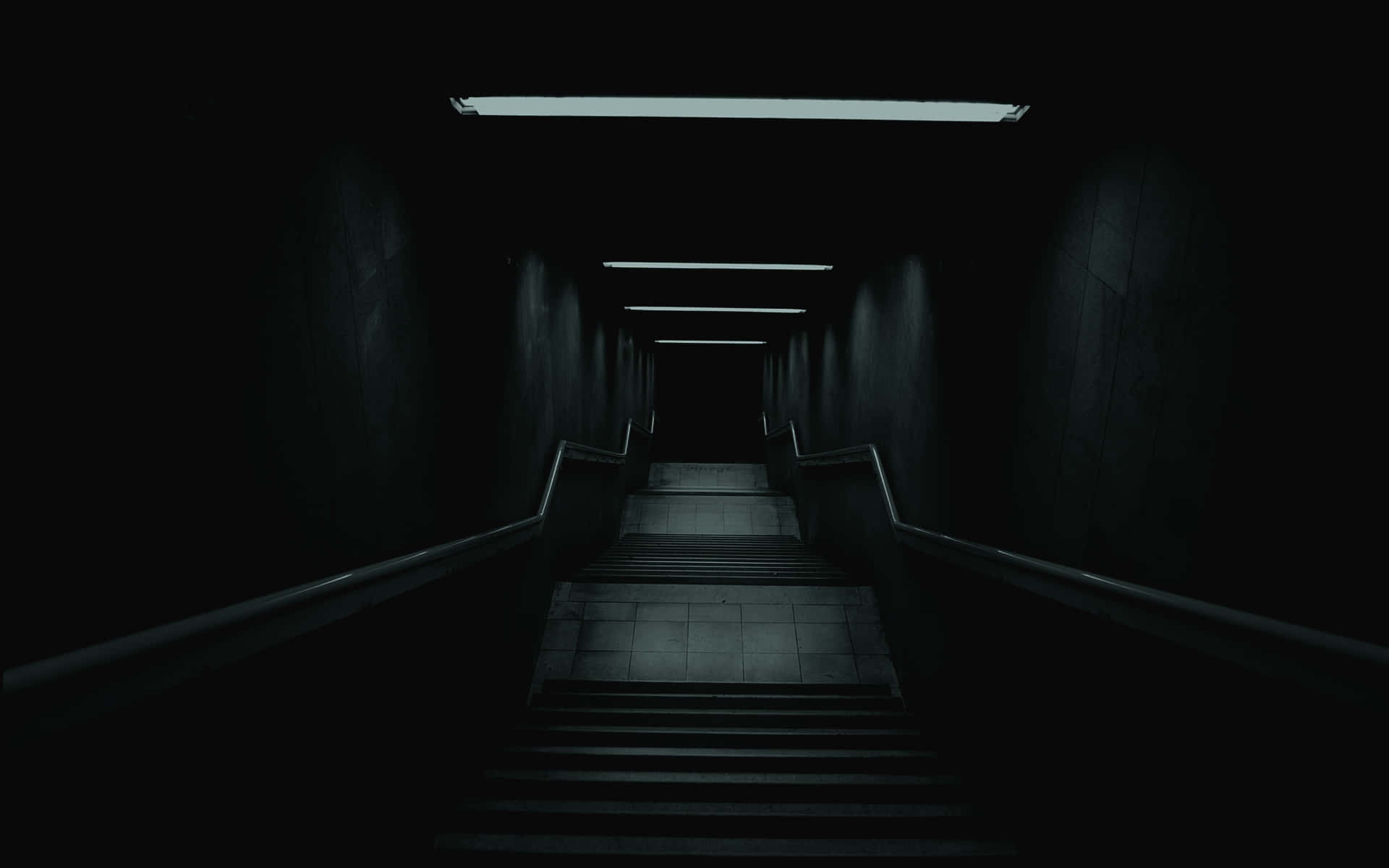 dark hallway with stairs leading to a dark room