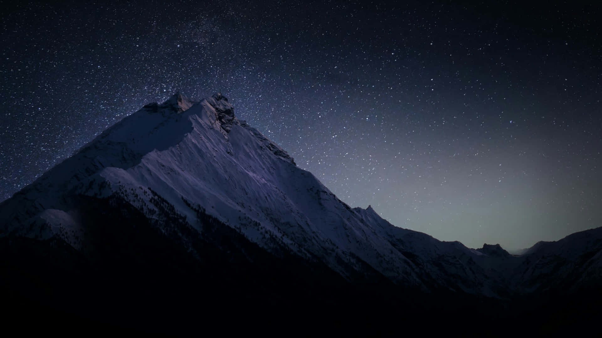 a mountain with stars above it at night