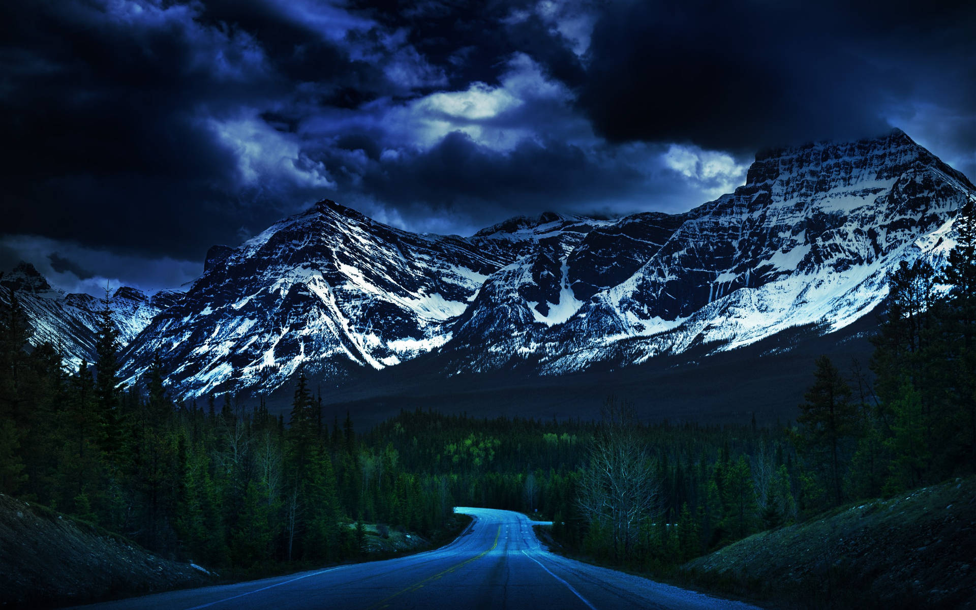 Dark Blue Clouds Over Snowy Mountains Wallpaper