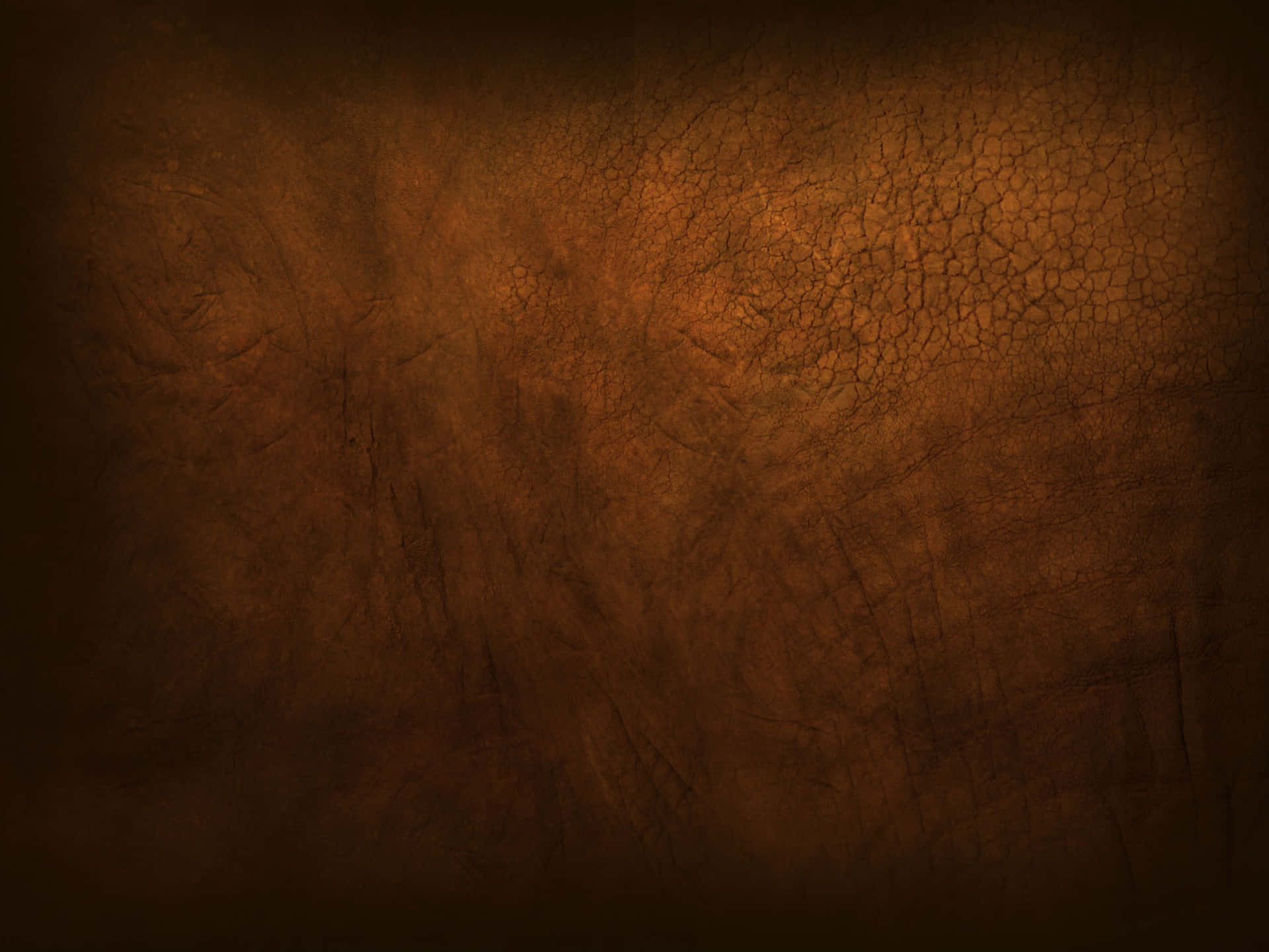 A Brown Leather Background With Dark Spots